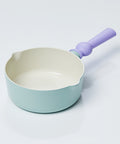 A petite pastel-colored wok with a light green body and a purple handle, displayed on a white background