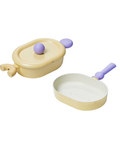 A set of two pastel-colored cookware items, including a yellow oval pot with a lid and a yellow grill pan, both with purple handles, displayed on a white background