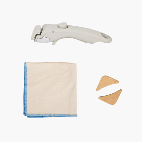 A set of cooking accessories, including a handle attachment, a cloth, and wooden corner pieces.