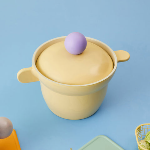 Modern pastel yellow rice pot with a purple knob, aesthetic ceramic cookware on a light blue background."

Keywords: yellow rice pot, ceramic cookware, pastel kitchenware, aesthetic cooking pot, rice cooker

