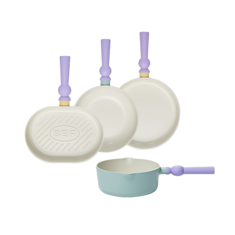 A set of four pastel-colored cookware pieces, including an oval grill pan, two frying pans, and a small pot with light green bodies and purple handles, displayed on a white background