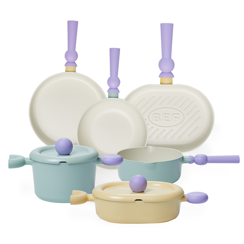 An assortment of pastel-colored cookware, including various pots and pans with unique, colorful handles and lids, displayed togethe