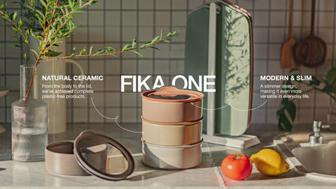 FIKA ONE ceramic containers stacked on a kitchen counter, highlighting their natural ceramic and modern, slim design. The image shows a stylish, eco-friendly kitchen setting with a plant in a glass vase and fresh produce, emphasizing the product's versatility and plastic-free composition