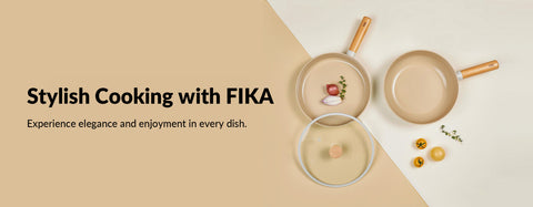 Elegant kitchenware advertisement featuring two beige cooking pans and a pot on a light cream background. One pan is covered with a glass lid, revealing a sprig of herbs inside, while the other displays a raw steak with rosemary and spices. Scattered ingredients, including herbs, peppercorns, and garlic cloves, accent the composition. At the top, the text reads 'Stylish Cooking with FIKA - Experience elegance and enjoyment in every dish' in a stylish, modern font.