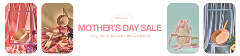 Promotional banner for a Mother's Day Sale, featuring a sequence of four panels with artistic displays of kitchenware. The first panel shows kitchen items in a red and pink floral setting; the second presents them amidst golden accents; the third highlights a whimsical setup with a mouse figurine; and the fourth displays items against a blue striped background. The central text announces 'Shop now! Mother's Day Sale - Enjoy 10% off and earn a 10% e-Gift Card.
