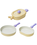 A set of three pastel-colored cookware items, including a yellow oval pot with a lid, a yellow frying pan, and a yellow grill pan, all with purple handles, displayed on a white background