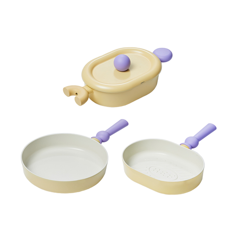 A set of three pastel-colored cookware items, including a yellow oval pot with a lid, a yellow frying pan, and a yellow grill pan, all with purple handles, displayed on a white background